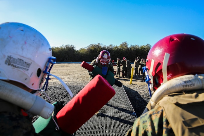 Recruits of Lima Company, 3rd Recruit Training Battalion, square up to fight each other during a pugil stick bout at Marine Corps Recruit San Diego, Dec. 4. Once in the arena, the fighters were checked by the Marine Corps Martial Arts Instructor or a drill instructor to ensure their gear was properly worn before their bout began.