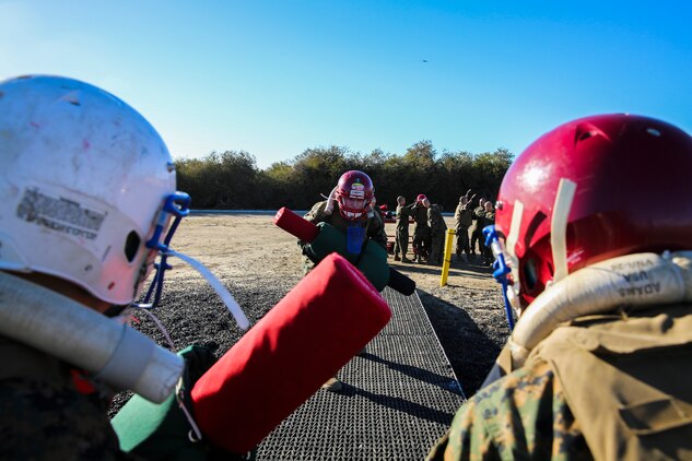 Recruits of Lima Company, 3rd Recruit Training Battalion, square up to fight each other during a pugil stick bout at Marine Corps Recruit San Diego, Dec. 4. Once in the arena, the fighters were checked by the Marine Corps Martial Arts Instructor or a drill instructor to ensure their gear was properly worn before their bout began.
