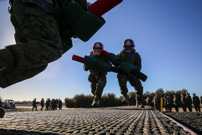 Recruits of Lima Company, 3rd Recruit Training Battalion, fight each other during a pugil stick bout at Marine Corps Recruit San Diego, Dec. 4. Once in the arena, the fighters were checked by the Marine Corps Martial Arts Instructor or a drill instructor to ensure their gear was properly worn before their bout began.