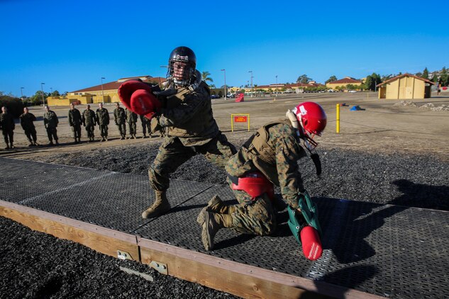Recruits of Lima Company, 3rd Recruit Training Battalion, fight each other during a pugil stick bout at Marine Corps Recruit San Diego, Dec. 4. Before the battles began, recruits donned their protective gear because once in the arena, they used full force. Helmets, groin protector, flak jackets, gloves and mouthpieces were given to each recruit.
