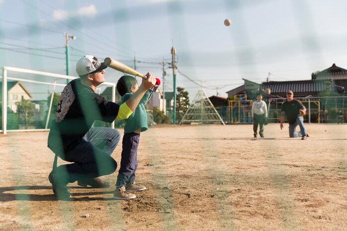 Volunteers from Marine Corps Air Station Iwakuni, Japan, play baseball with children during a visit to an children’s home in Houfu, Japan, Dec. 23, 2014. The Marine Thrift Store hosted the visit after collecting toys during a toy drive and motorcycle rally earlier this year. The rally collected more than 300 toys to give to the children’s home. 