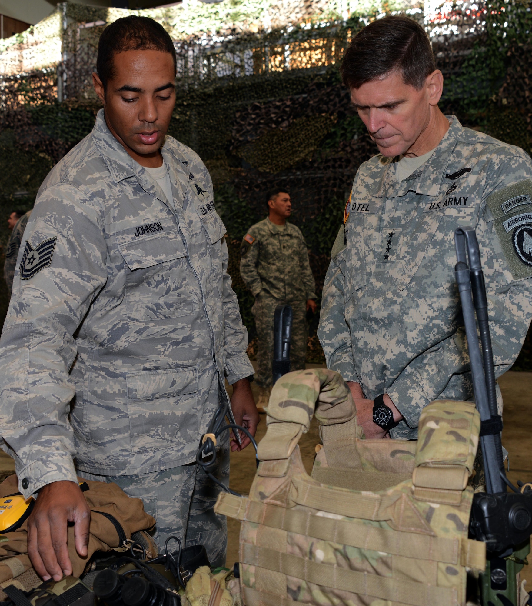 From left, Tech. Sgt. William Johnson, a combat controller with the 320th Special Tactics Squadron, briefs U.S. Army Gen.  Joseph Votel during a visit Dec. 15, 2014 on Kadena Air Base, Japan.  As commander of the U.S. Special Operations Command, Votel visited the 353rd Special Operations Group where he toured facilities and met with the Airmen and their spouses. The visit ended with a town hall meeting where the general spoke to the Airman and their spouses about the future of special operations.  (U.S. Air Force photo by Tech. Sgt. Kristine Dreyer)