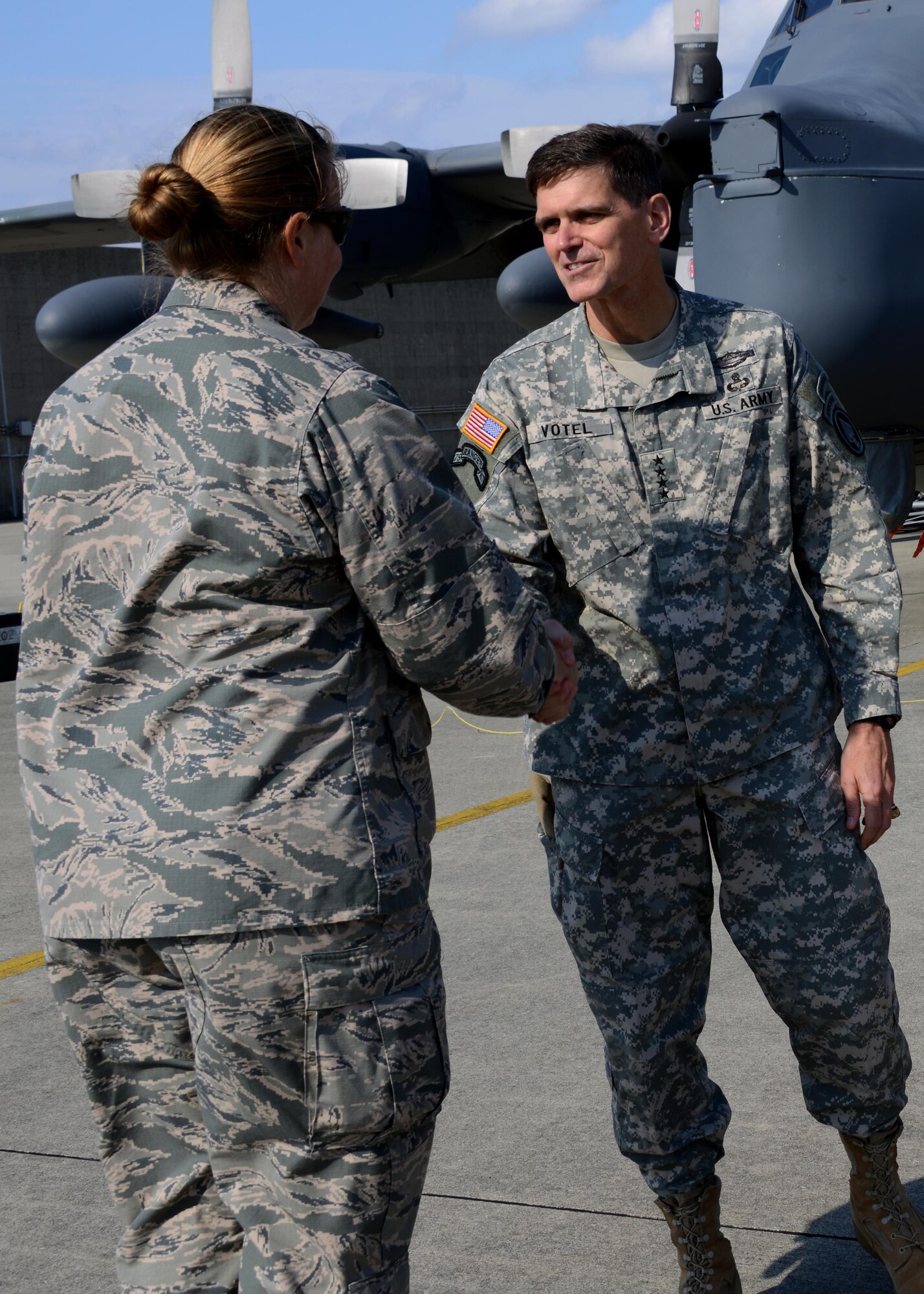 U.S. Army Gen.  Joseph Votel, commander of U.S. Special Operations Command shakes hands with Lt. Col. Sarah Emory, commander of the 353rd Special Operations Maintenance Squadron, after touring the flightline Dec. 15, 2014 on Kadena Air Base, Japan.  Votel directs all U.S. Special Operations Forces and is in charge of organizing, training, equipping and deploying special operators such as the Air Commandos of the 353rd Special Operations Group. (U.S. Air Force photo by Tech. Sgt. Kristine Dreyer) 
