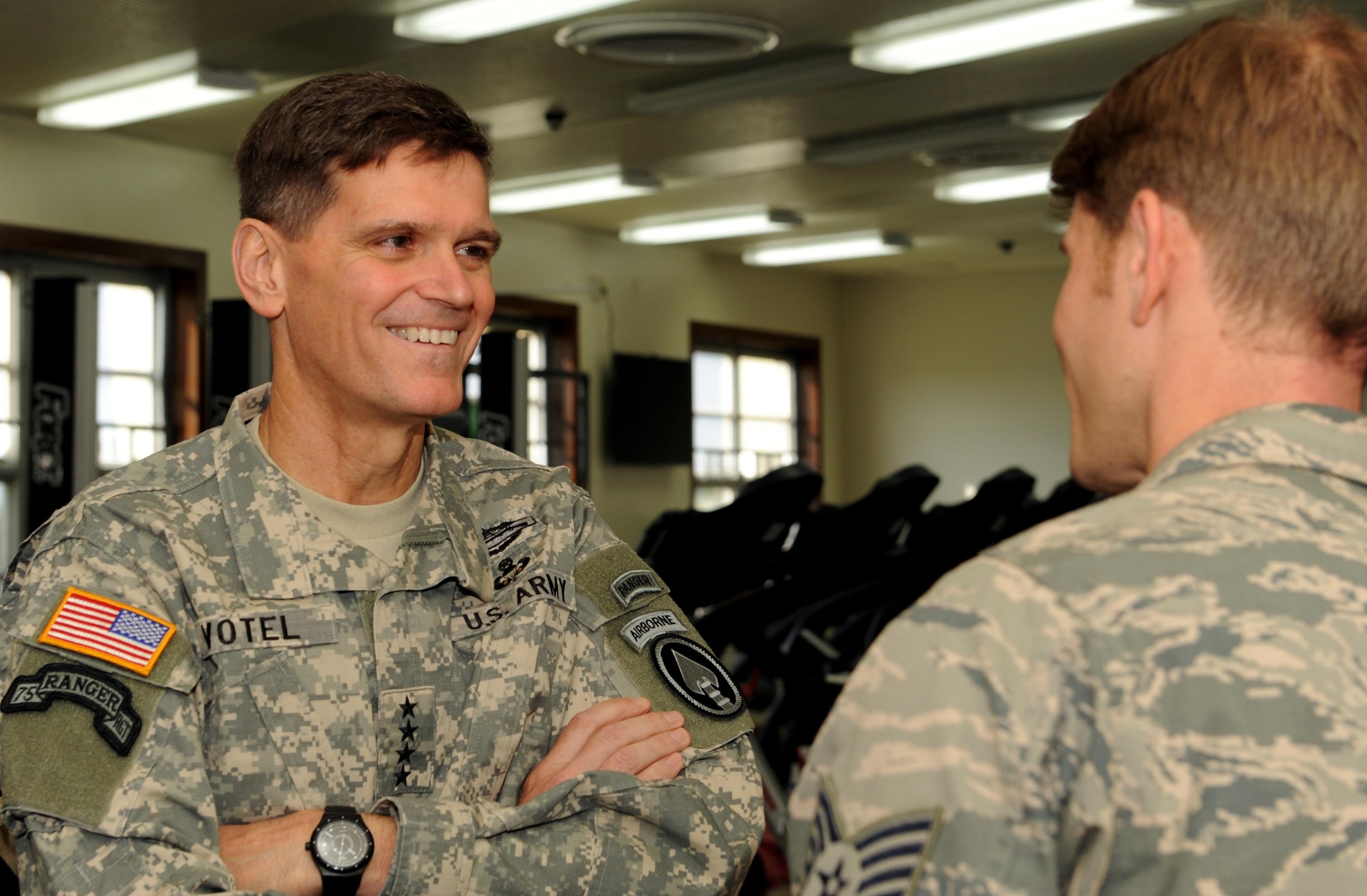 U.S. Army Gen. Joseph Votel, commander of U.S. Special Operations Command, speaks with Staff Sgt. Dustin Gorski, a pararescueman from the 320th Special Tactics Squadron, during a visit to the Human Performance Center at Kadena Air Base, Japan Dec. 15, 2014.  General and Mrs. Votel toured the facilities and met with staff members to see the program’s efforts in support of the Preservation of the Force and Family initiative.  (U.S. Air Force photo by Airman 1st Class Zade Vadnais)