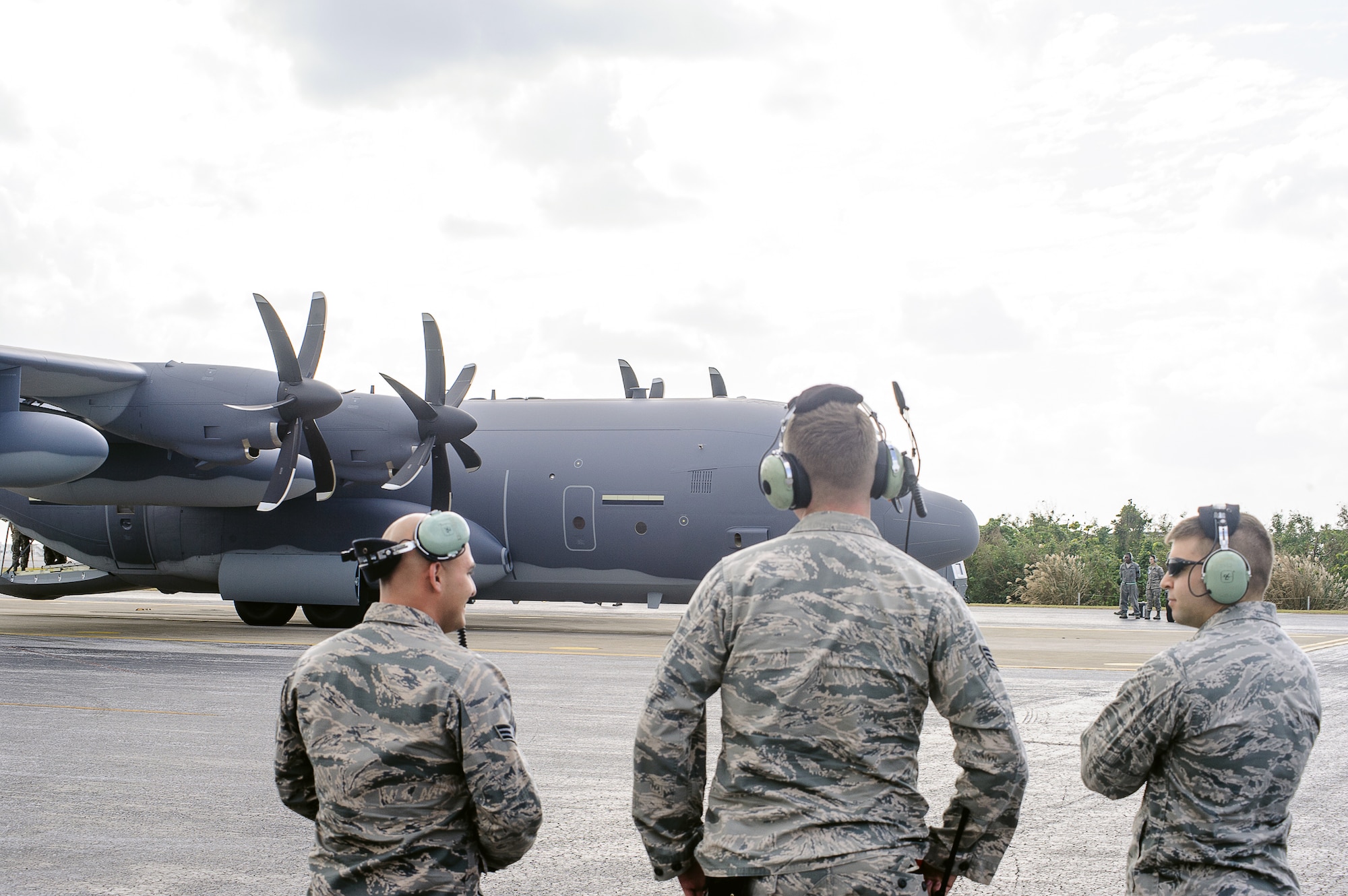 Airmen from the 353d Special Operations Maintenance Squadron discuss the new MC-130J Commando II as it taxis on the flightline of Kadena Air Base, Japan, Dec. 21, 2014. The MC-130J is part of Air Force Special Operations Command’s fleet-wide C-130 recapitalization which began four years ago with the retirement of the MC-130E. (U.S. Air Force photo by Tech. Sgt. Alexy Saltekoff)