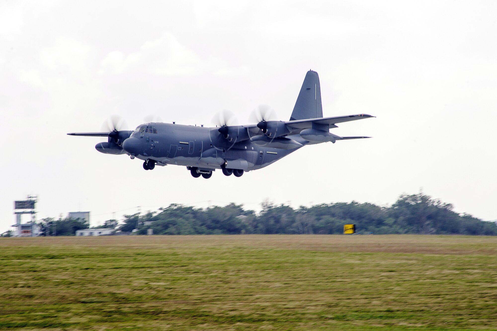 An MC-130J Commando II extends its landing gear above the flightline on Kadena Air Base, Japan, Dec. 21, 2014. The MC-130J will replace the MC-130P Combat Shadow aircraft assigned to the 353rd Special Operations Group’s 17th Special Operations Squadron. (U.S. Air Force photo by Tech. Sgt. Alexy Saltekoff)