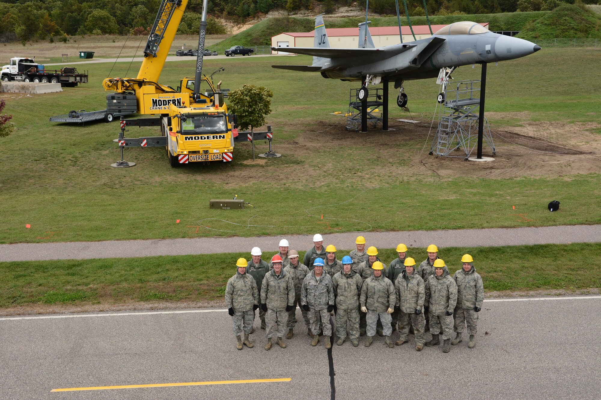 Airmen from the Crash, Damage, Disabled Aircraft Recovery training team pose in front of a jet they recovered during an exercise at Volk Field Air National Guard Base, Camp Douglas, Wis., Oct. 4, 2014. CDDAR teams from across the nation were tested with simulated aircraft crash exercises, and as their leadership stood back, were forced to make decisions on how to transport and/or recover the aircraft. (U.S. Air National Guard photo by Staff Sgt. Ryan Roth)
