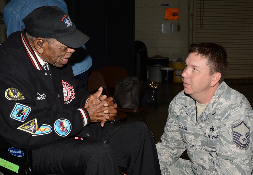 Homer Hogues, a Tuskegee Airman, talks with Master Sgt. Wesley Clark, 2nd Aircraft Maintenance Squadron, during a visit to Barksdale Air Force Base, La., Dec. 27, 2014. During the visit, two Tuskegee Airmen spoke about aviation from their generation with Barksdale Airmen. (U.S. Air Force photo/Senior Airman Benjamin Gonsier)