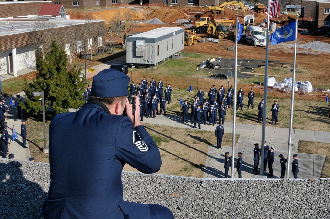 MCGHEE TYSON AIR NATIONAL GUARD BASE, Tenn. - Master Sgt. Jerry Harlan photographs Airmen here Nov. 19, 2014, during thier reatreat ceremony and graduation from Airman Leadership School and NCO Academy at the I.G. Brown Training and Eduation Center. (U.S. Air National Guard photo by Master Sgt. Mike R. Smith/Released)