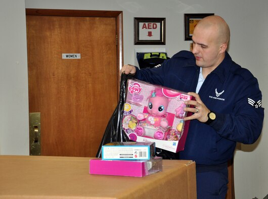 WRIGHT-PATTERSON AIR FORCE BASE, Ohio – Senior Airman Brandon Hakes, 87th Aerial Port Squadron orderly room, helps load toys to be delivered to children at the Dayton Children’s Hospital Dec. 19, 2014. More than a dozen 87th APS reservists handed out toys donated by their fellow Airmen to the young patients. This is the squadron’s 24th year handing out toys at the hospital. (U.S. Air Force photo/Stacy Vaughn)