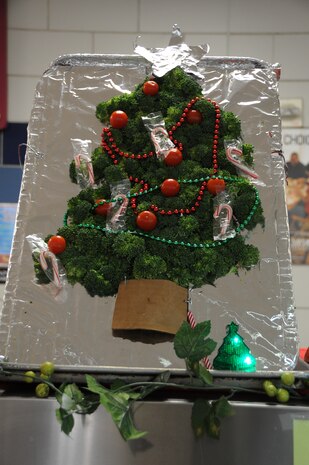 A broccoli and tomato Christmas tree stands on display at the Weapons Station Galley, Dec. 25, 2014, at Joint Base Charleston, S.C. Cheryl Cote and Elizabeth Bohr, Galley line supervisors, were asked to add ambiance for the Sailors by creating decorations from readily available kitchen items. The Galley staff and their Air Force counterparts at the Gaylor Dining Facility on the Air Base, prepared delicious meals for service members at Joint Base Charleston, many of whom are stationed away from friends and families. (U.S. Air Force photo/Capt. Christopher Love)