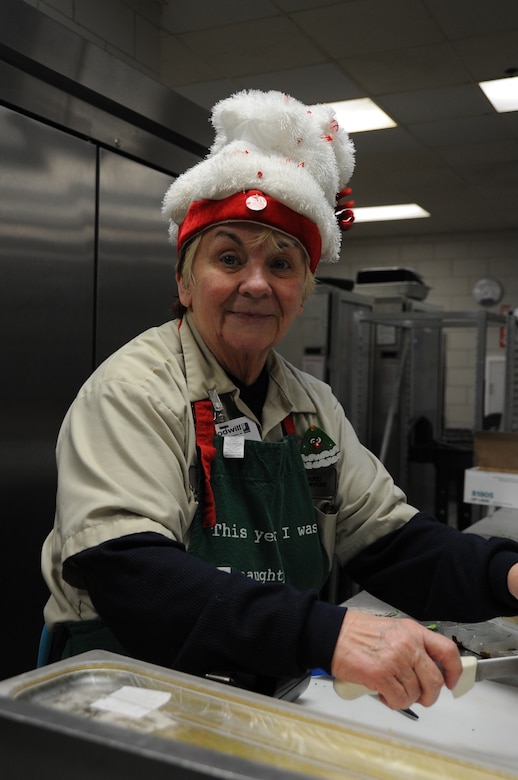 Cheryl Cote, Weapons Station Galley line supervisor, prepares Christmas dinner for Sailors at the Weapons Station, Dec. 25, 2014, at Joint Base Charleston, S.C. The Galley staff served ham, prime rib and all the “fixin’s” to Sailors at the Navy Nuclear Power Training Command, who spent the holidays away from friends and family. (U.S. Air Force photo/Capt. Christopher Love)