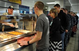 Master Chief Petty Officer Joseph Gardner, Naval Support Activities Charleston command master chief, chats with a Sailor while serving mashed potatoes at the Weapons Station Galley as part of a Christmas meal Dec. 25, 2014, at Joint Base Charleston, S.C. It is customary for senior military leaders to serve junior service members during the holidays to foster morale and to thank those who accomplish the mission throughout the year. (U.S. Air Force photo/Capt. Christopher Love)