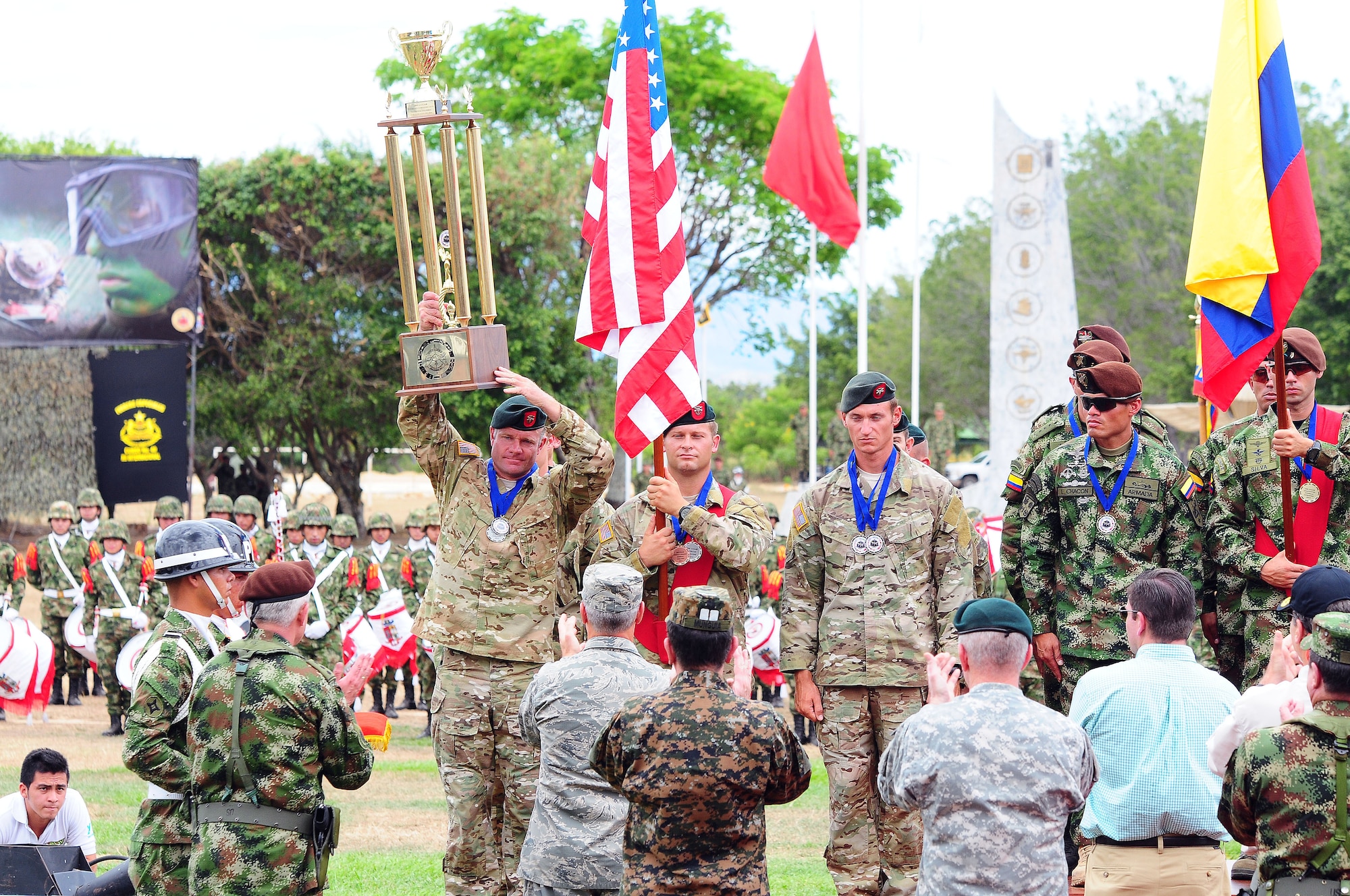 U.S. Soldiers assigned to the 7th Special Forces Group hoist the second place trophy during the closing ceremony of the Fuerzas Comando 2014 competition July 31 in Fort Tolemaida, Colombia. The second place finish was the best performance by the U.S team since the competition was established in 2004. (U.S. Army photo by Staff Sgt. Angel Martinez)