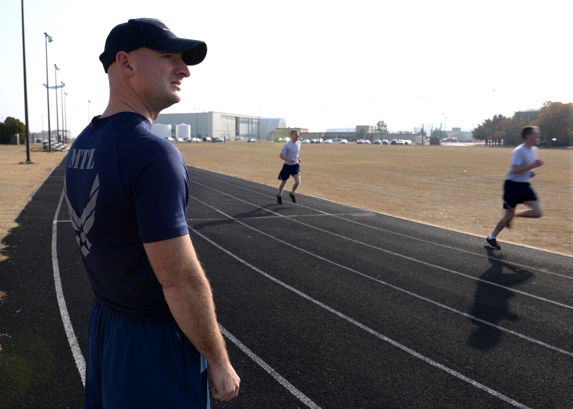 ALTUS AIR FORCE BASE, Okla. – U.S. Air Force Staff Sgt. Timothy Rowland, 97th Training Squadron military training leader, oversees physical training for Airmen in technical training, Dec. 11, 2014. Rowland has been a military training leader for over three years. (U.S. Air Force photo by Airman 1st Class Nathan Clark/Released)