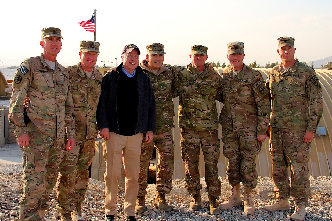 From left to right, U.S. Army Command Sgt. Maj. Roger Heinze, U.S. Army Brig. Gen. Christopher Bentley, U.S. Senator John McCain, R-Ariz., U.S. Army Gen. John Campbell, commander, International Security Assistance Force,  Sgt. Maj. Delbert Byers, U.S. Army Col. Cameron Cantlon, and U.S. Army Lt. Col. Cale Brown stop for a group photograph during McCain’s visit to Tactical Base Gamberi in Laghman province, Afghanistan, Dec. 25, 2014.