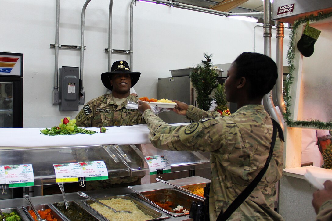 U.S. Army Maj. Eric Lightfoot, left, serves Christmas dinner to a soldier in the dining facility at Tactical Base Gamberi in Laghman province, Afghanistan, Dec. 25, 2014. 
Lightfoot is an adviser assigned to the 3d Cavalry Regiment, Train, Advise, Assist Command – East.