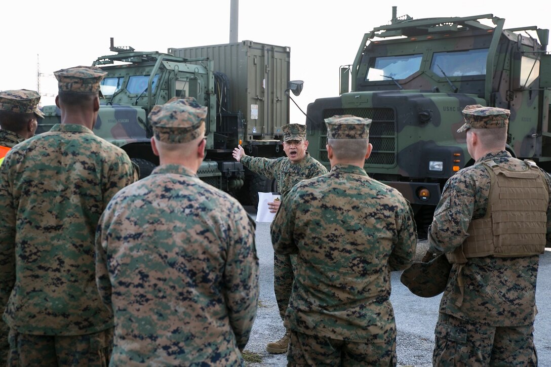 Master Gunnery Sgt. Alex C. Cabero Jr., center, explains an upcoming event Dec. 9 to a group of Marines at Camp Kinser during a Truck Rodeo. The rodeo increased camaraderie and refreshed basic motor transportation skills for Marines stationed across Okinawa. Cabero, from Vista, California, is the unit movement control chief with 3rd Marine Logistics Group, III Marine Expeditionary Force. 