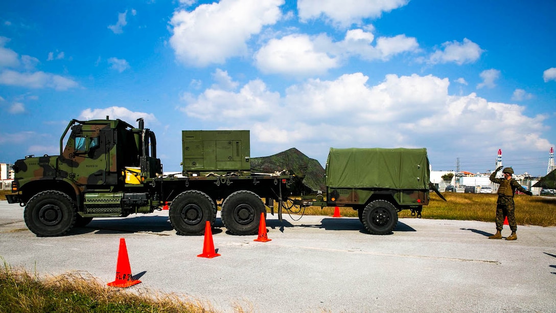 Marines navigate a Medium Tactical Vehicle Replacement, also known as the 7-Ton, through a set of zig-zag cones Dec. 9 as part of a Truck Rodeo on Camp Kinser. The rodeo had multiple events designed to test motor transport units, which came from different bases on Okinawa. It was also a good opportunity to build camaraderie among the motor transport community. The Marines are with Marine Air Control Group 18, 1st Marine Aircraft Wing, III Marine Expeditionary Force. 