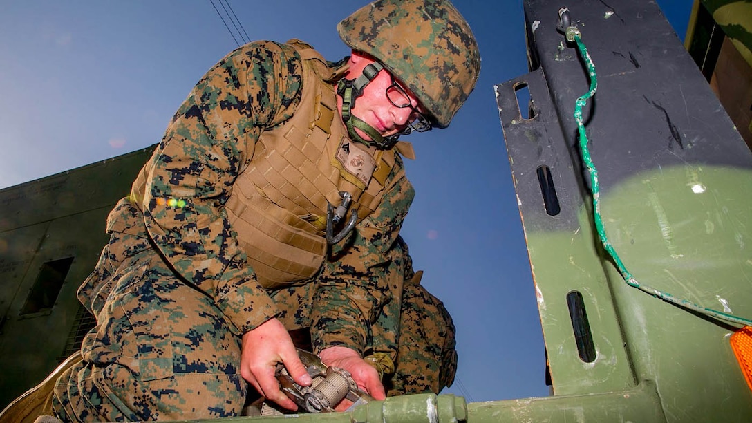 Cpl. Luke E. Heilig straps down a generator to a Medium Tactical Vehicle Replacement or 7-Ton, Dec. 9, during a Truck Rodeo on Camp Kinser as part of an evaluation before driving the truck through an obstacle course. The rodeo brought motor transport Marines from different units together to build camaraderie and test their skills. Heilig, from Pittsburgh, Pennsylvania, is a motor transport operator with Headquarters Regiment, 3rd Marine Logistics Group, III Marine Expeditionary Force. 
