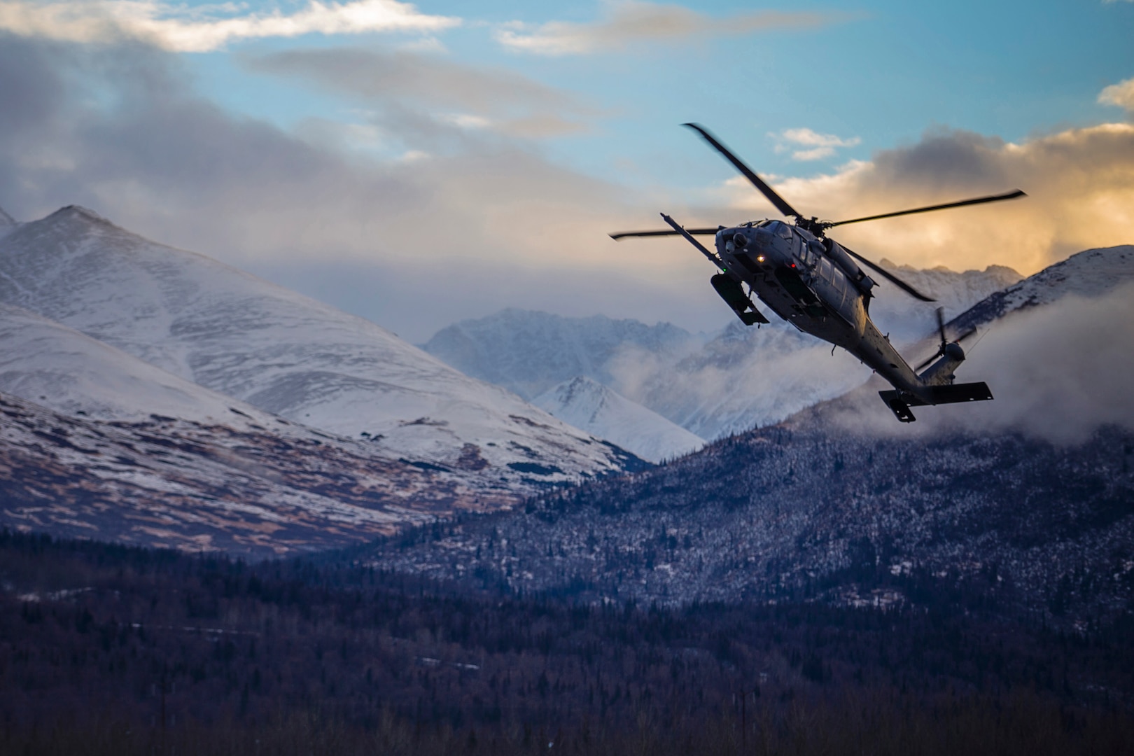 An HH-60 Pave Hawk helicopter from the 210th Rescue Squadron, Alaska Air National Guard, practices “touch and go” maneuvers at Bryant Army Airfield on Joint Base Elmendorf-Richardson, Dec. 17, 2014. A similar craft rescued a snowmobiler.