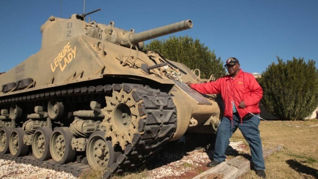 Kenny R. White, Marine veteran, native of San Diego, Calif., poses with a Sherman Tank outside of 1st Tank Battalion’s headquarters building, Dec. 22, 2014. White received a tour of the M1A1 Abrams tank, and was able to see the Advance Gunnery Training Simulator as well. 