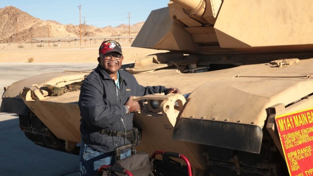 Kenny R. White, Marine veteran, native of San Diego, Calif., hugs a tank on the 1st Tank Battalion ramp, Dec. 22, 2014. White suffers from Stage 5-kidney failure and one of his most important final wishes was to hug a tank. 
