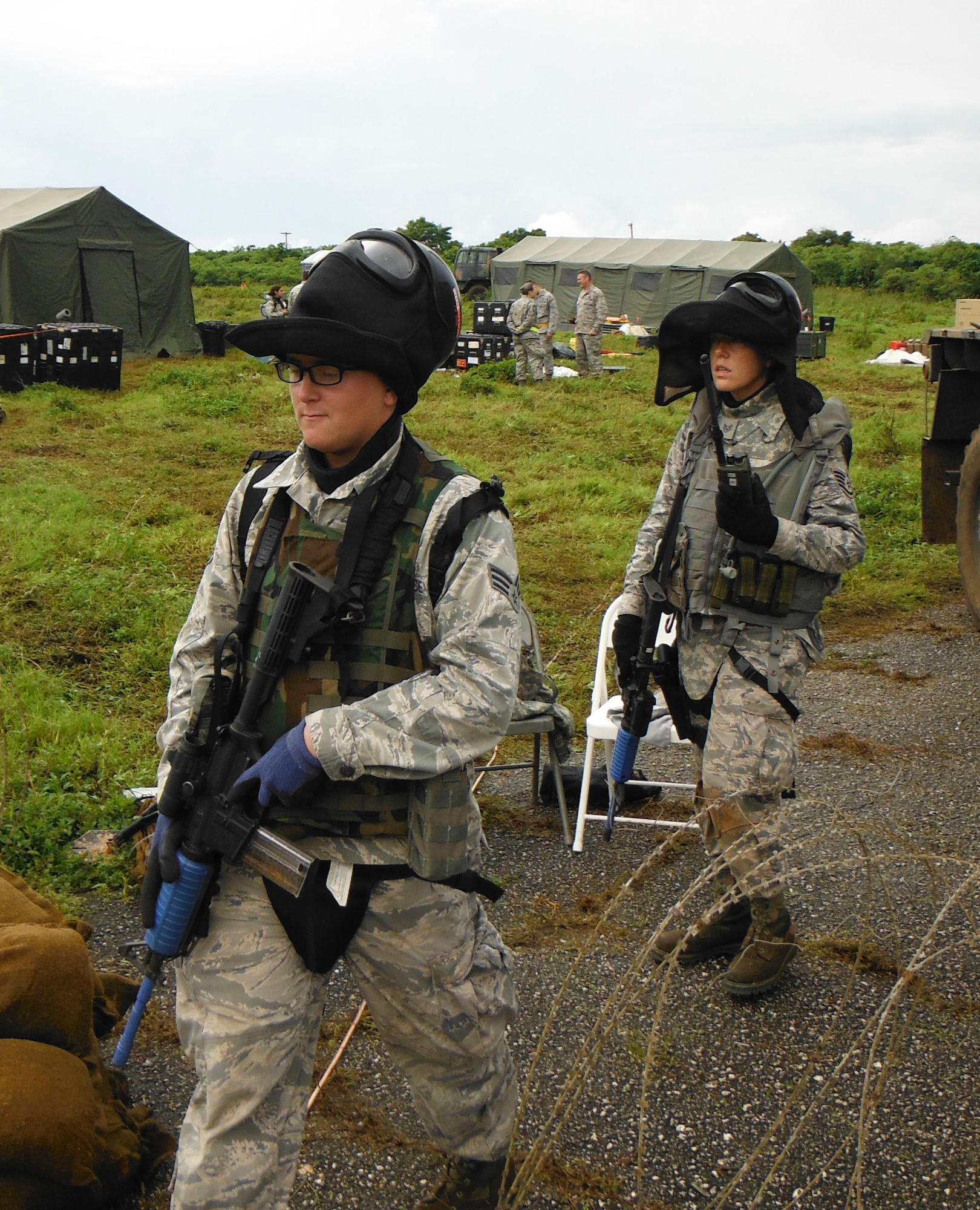 Senior Airman Joseph Wacaster and Staff Sgt. Kaitlyn Grotegut leave an entry control point to conduct a perimeter check during an exercise Oct. 28, 2014, at Andersen Air Force Base, Guam. The exercise allowed Airmen from the 644th CBCS to practice their abilities to respond to various scenarios during contingency operations. The Airmen are from the 644th Combat Communication Squadron. (Courtesy photo)