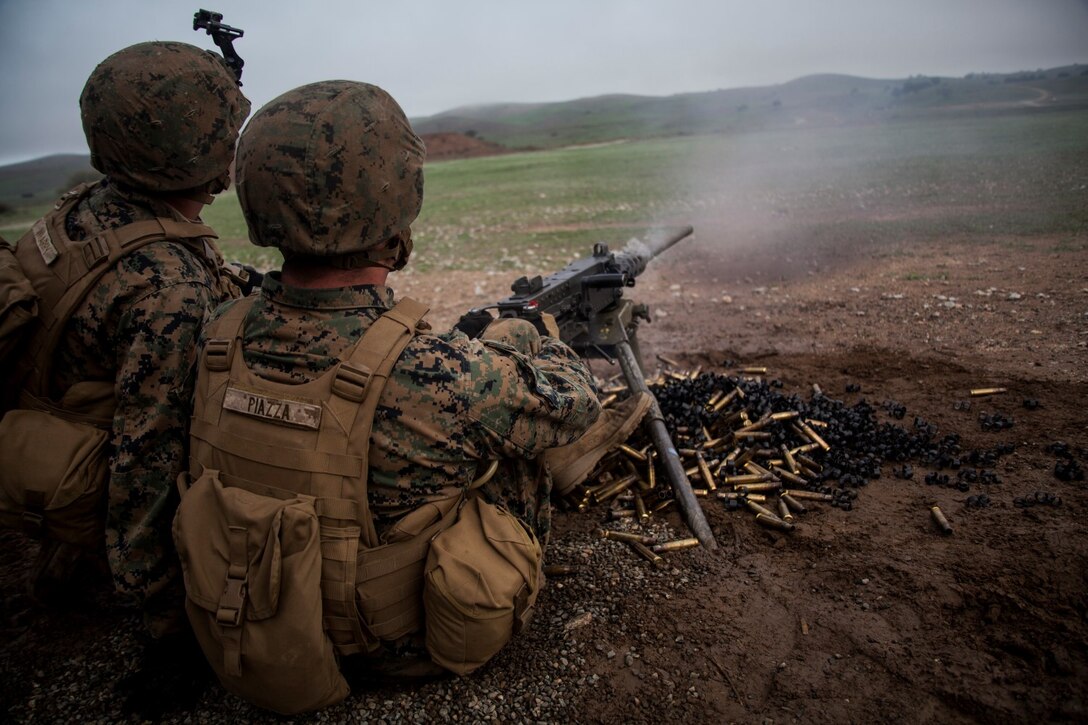 U.S. Marine Pfc. Jacob Piazza, right, fires a .50-caliber machine gun at targets during realistic urban training aboard Camp Roberts, Calif., Dec. 14, 2014. Piazza is a rifleman with Weapons Company, Battalion Landing Team 3rd Battalion, 1st Marine Regiment, 15th Marine Expeditionary Unit. RUT prepares the 15th MEU’s Marines for their upcoming deployment, enhancing their combat skills in environments similar to those they may find in future missions. (U.S. Marine Corps photo by Cpl. Elize McKelvey/Released)