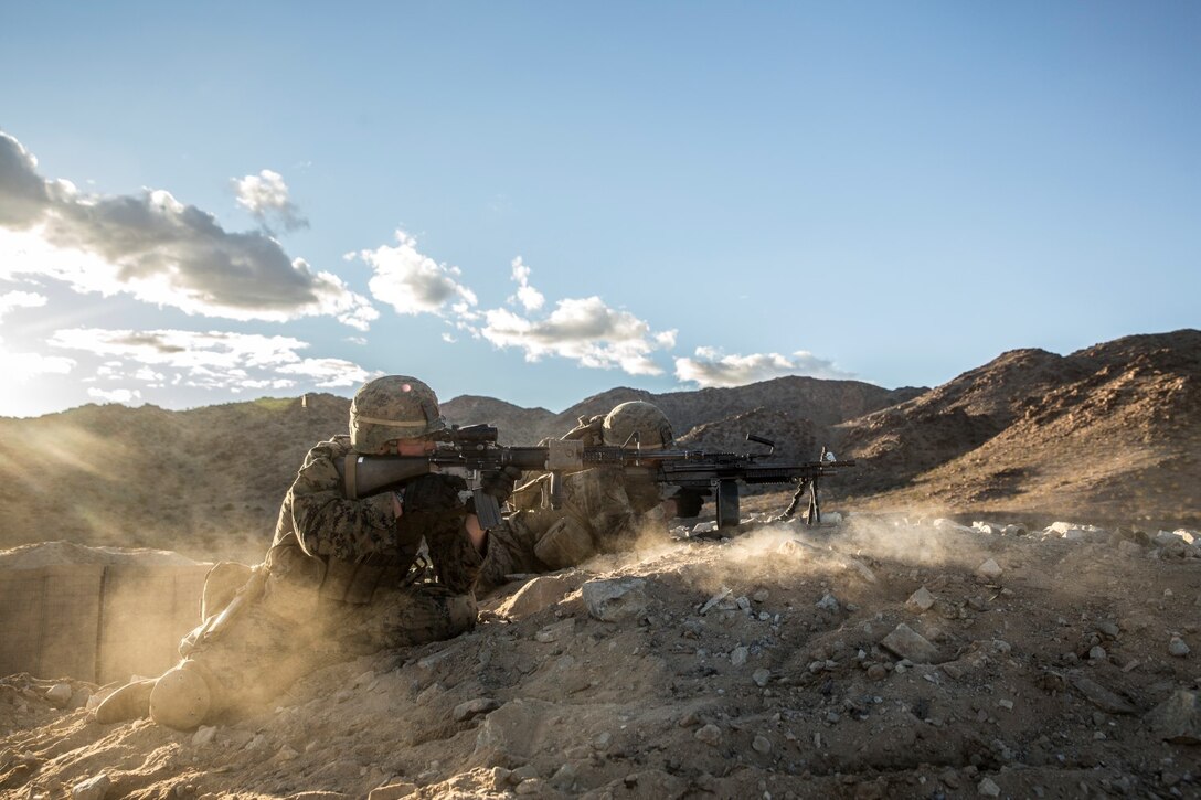 U.S. Marines Lance Cpl. Dylan Brooks, left, and Pfc. Andres Bravo engage targets during a combined arms exercise aboard Marine Corps Air Ground Combat Center, Twentynine Palms, Calif., Dec. 13, 2014. Brooks is a radio operator and Bravo is a rifleman with Battalion Landing Team 3rd Battalion, 1st Marine Regiment, 15th Marine Expeditionary Unit. BLT 3/1 conducted this training concurrent with the 15th MEU’s realistic urban training.  RUT prepares the 15th MEU’s Marines for their upcoming deployment, enhancing their combat skills in environments similar to those they may find in future missions. (U.S. Marine Corps Photo by Sgt. Emmanuel Ramos/Released)