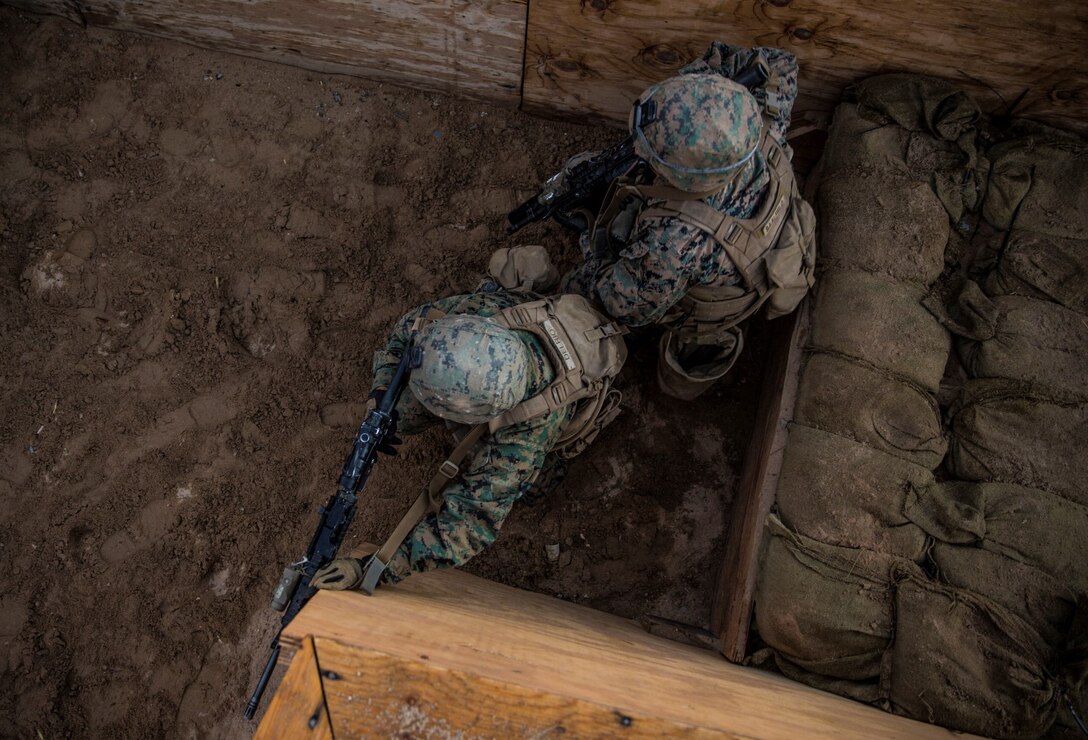 U.S. Marines with Battalion Landing Team 3rd Battalion, 1st Marine Regiment, 15th Marine Expeditionary Unit, clear a trench during a combined arms exercise aboard Marine Corps Air Ground Combat Center, Twentynine Palms, Calif., Dec. 12, 2014. BLT 3/1 conducted this training concurrent with the 15th MEU’s realistic urban training.  BLT 3/1 conducted this training concurrent with the 15th MEU’s realistic urban training.  RUT prepares the 15th MEU’s Marines for their upcoming deployment, enhancing their combat skills in environments similar to those they may find in future missions. (U.S. Marine Corps Photo by Sgt. Emmanuel Ramos/Released)
