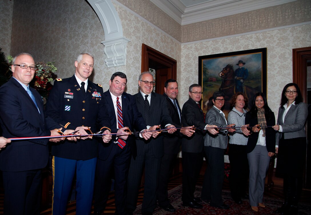Col. Christopher Barron joins partners in cutting the ribbon at the Watertown Arsenal property turnover in Watertown, Massachusetts, December 3, 2014.