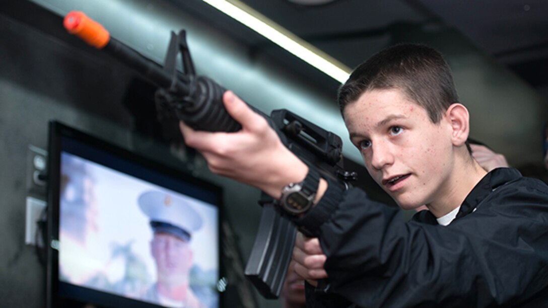 New York City—A student athlete tests his skills at an Indoor Simulated Marksmanship Trainer during the 2014 Marine Corps Holiday Classic at the New Balance Track and Field Center, Dec. 29, 2014. The Holiday Classic allowed the recruiters to educate students about the Marine Corps and its commitment to physical fitness. 