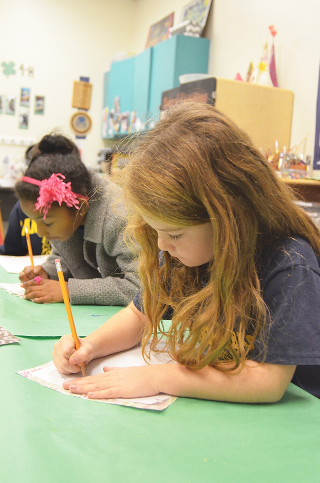 7-year-old Andrea Rector, at right, and 8-year-old Emily Key compose letters to Santa Claus.