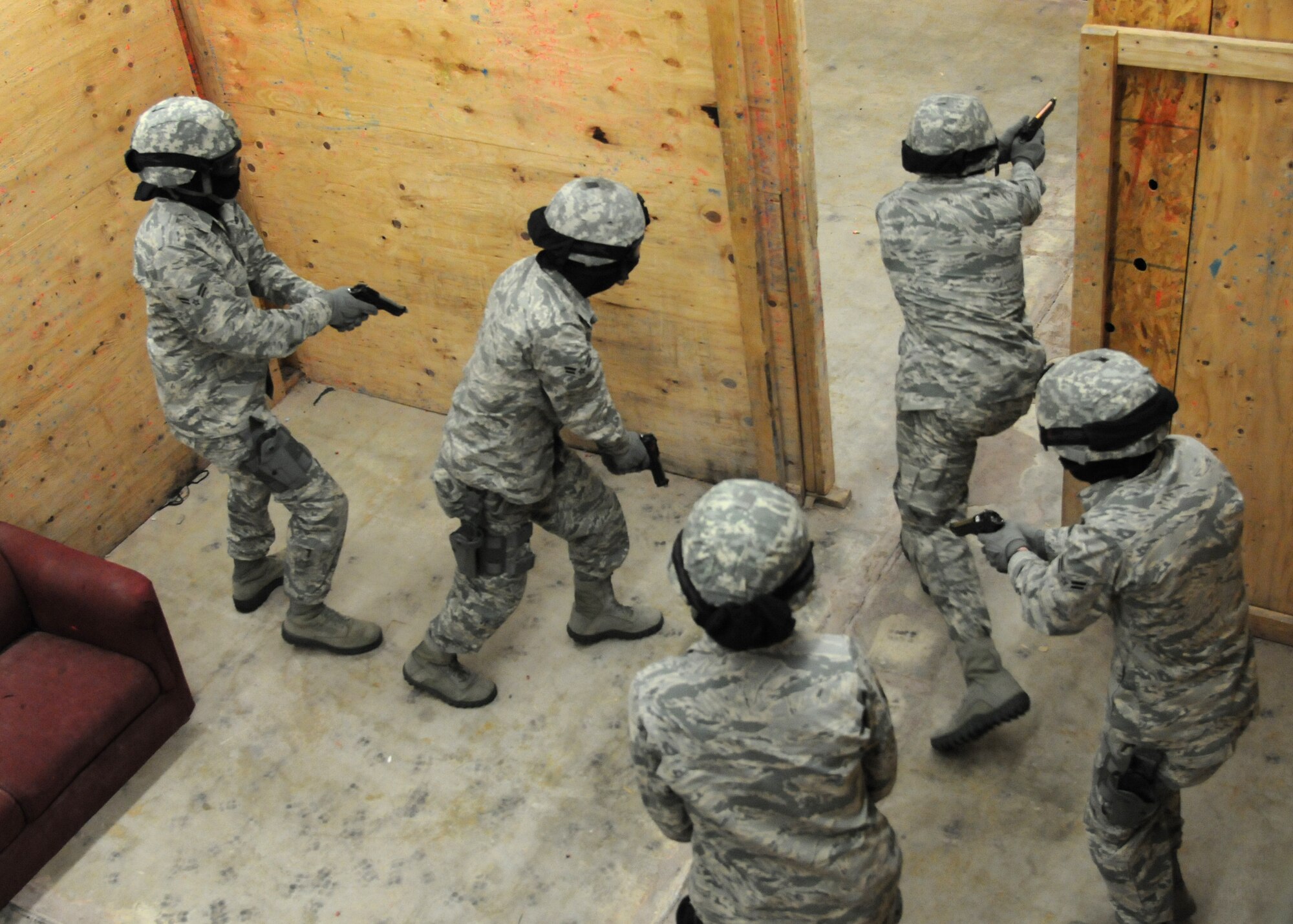 Security forces Airmen charge into a room during an active shooter scenario Dec. 22, 2014, in the shoot house on F.E. Warren Air Force Base, Wyo. When dealing with active shooters the Airmen are taught to head directly to and neutralize the threat. (U.S. Air Force photo/Airman 1st Class Malcolm Mayfield)