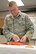 U.S. Air Force Senior Master Sgt. Billy Lain, a chaplain assistant in the 123rd Airlift Wing, prepares for Catholic Mass at the Kentucky Air National Guard Base in Louisville, Ky., Nov. 22, 2014, as part of his normal duties. Lain, who will retire soon, is now the pastor of his own church in rural Indiana. (U.S. Air National Guard photo by Staff Sgt. Vicky Spesard)