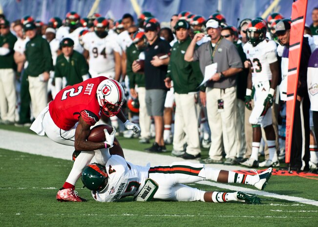Utah wide receiver Kenneth Scott tries to escape the grasp of Colorado State defensive back Shun Johnson after making a catch during the Las Vegas Bowl Dec. 20, 2014. Scott finished the game with six catches for 61 yards. (U.S. Air Force photo by Staff Sgt. Siuta B. Ika)