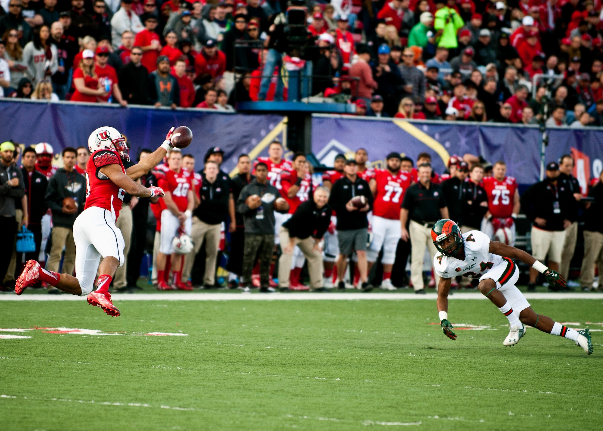 Utah running back Devontae Booker makes a leaping catch during the Las Vegas Bowl Dec. 20, 2014. In addition to his 162 yards rushing, Booker added 4 catches for 24 yards in his team’s 45-10 victory over Colorado State. (U.S. Air Force photo by Staff Sgt. Siuta B. Ika)