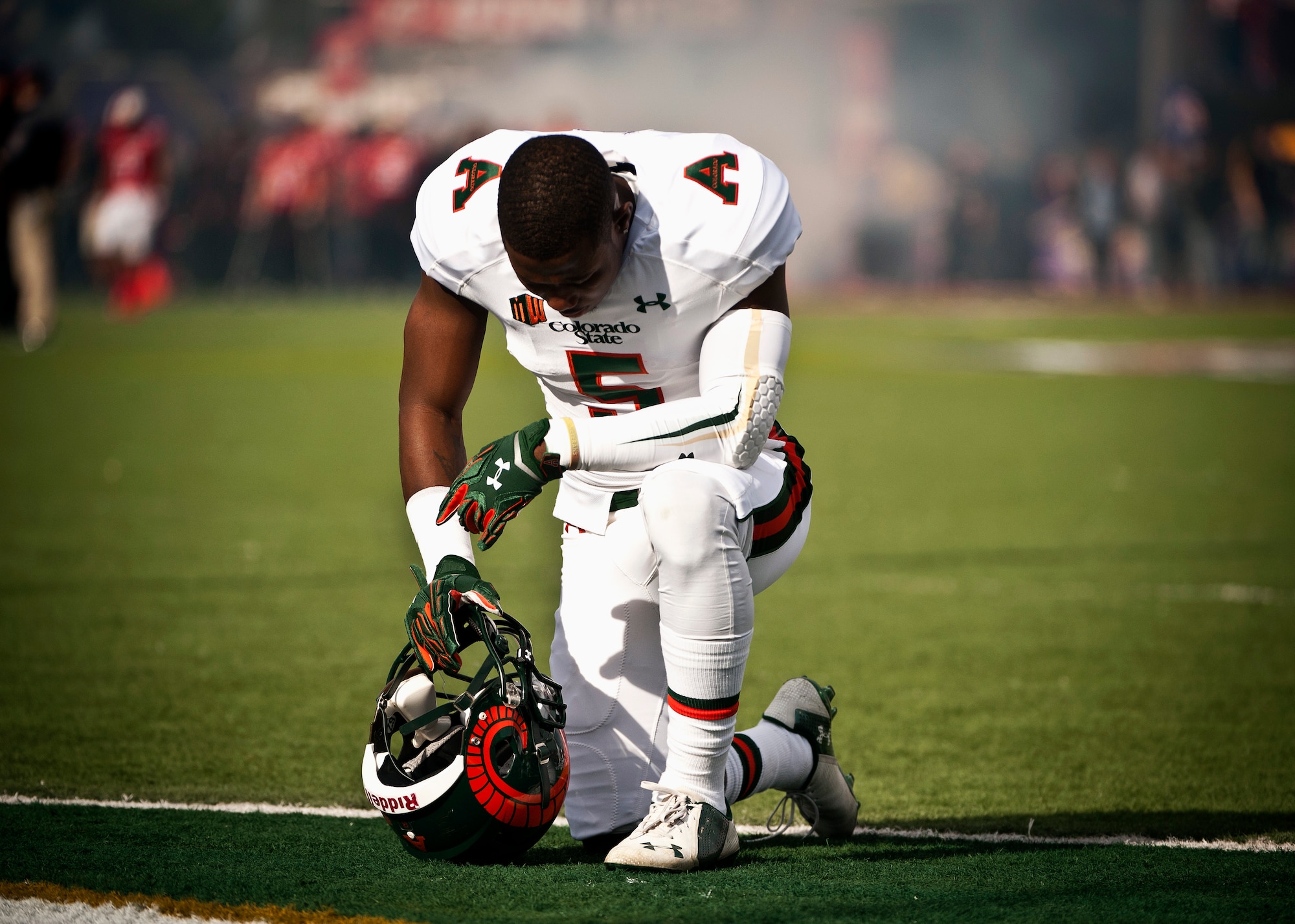 Colorado State defensive back Tyree Simmons kneels in prayer before the start of the Las Vegas Bowl Dec. 20, 2014. Simmons and the Colorado State defense gave up 548 total yards to the Utah offense in their 45-10 loss. (U.S. Air Force photo by Staff Sgt. Siuta B. Ika)