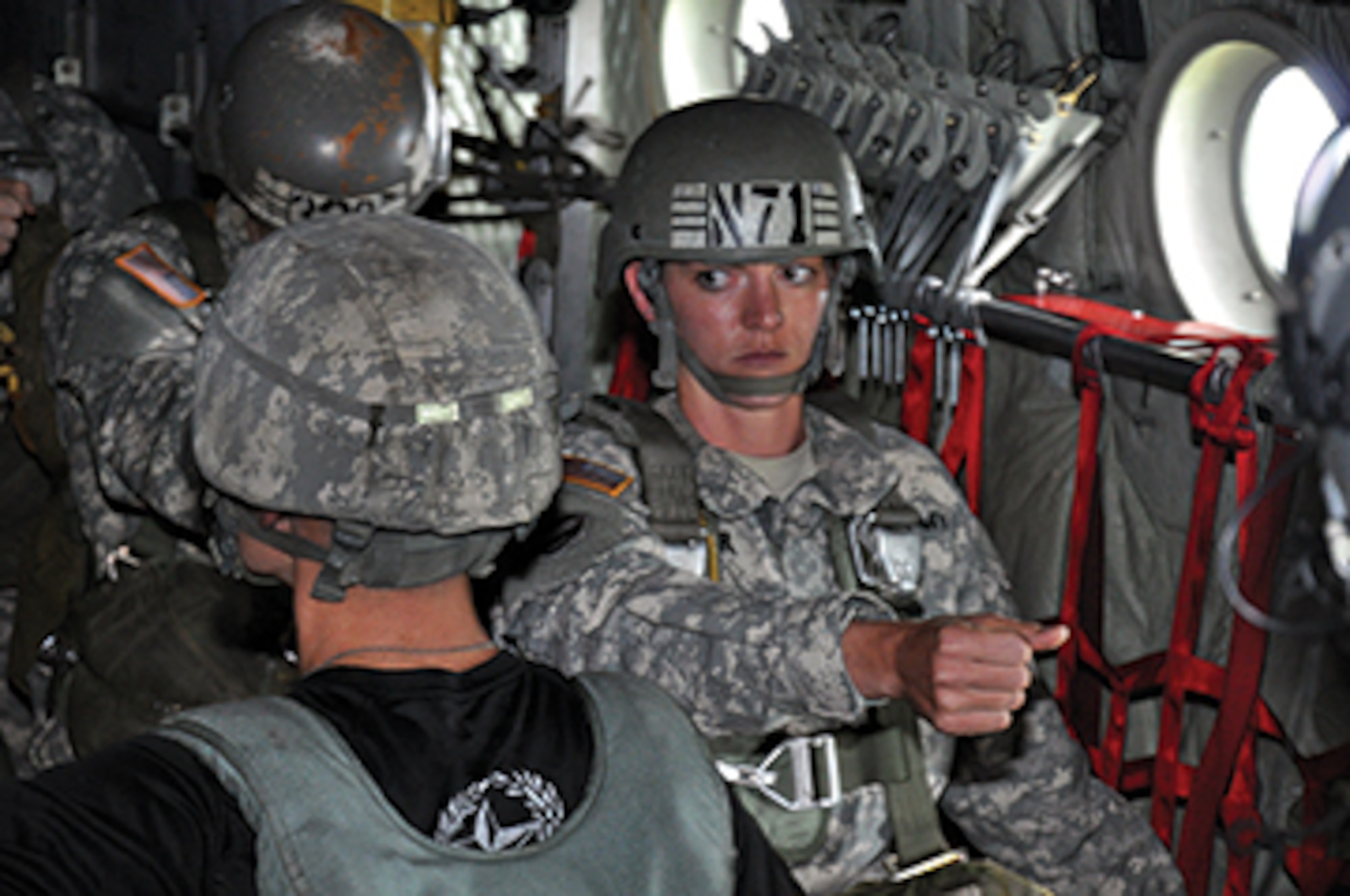 A soldier watches the jumpmaster for instructions during the final moments prior to jumping.