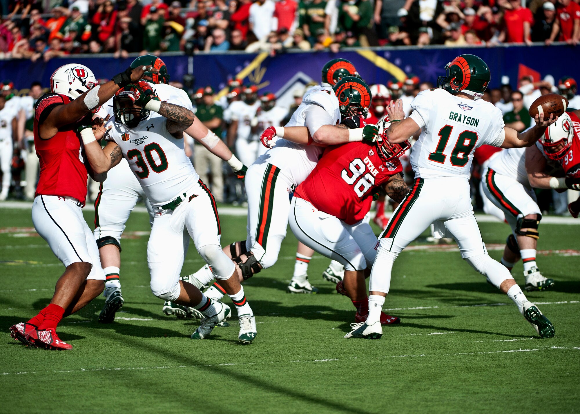 Colorado State quarterback Garrett Grayson attempts to throw the ball before the Utah defense reaches him during the Las Vegas Bowl Dec. 20, 2014. Although Grayson completed 20 passes for 227 yards and caught a 39 yard touchdown pass, he was sacked four times and threw an interception in his team’s 45-10 loss to Utah. (U.S. Air Force photo by Staff Sgt. Siuta B. Ika)