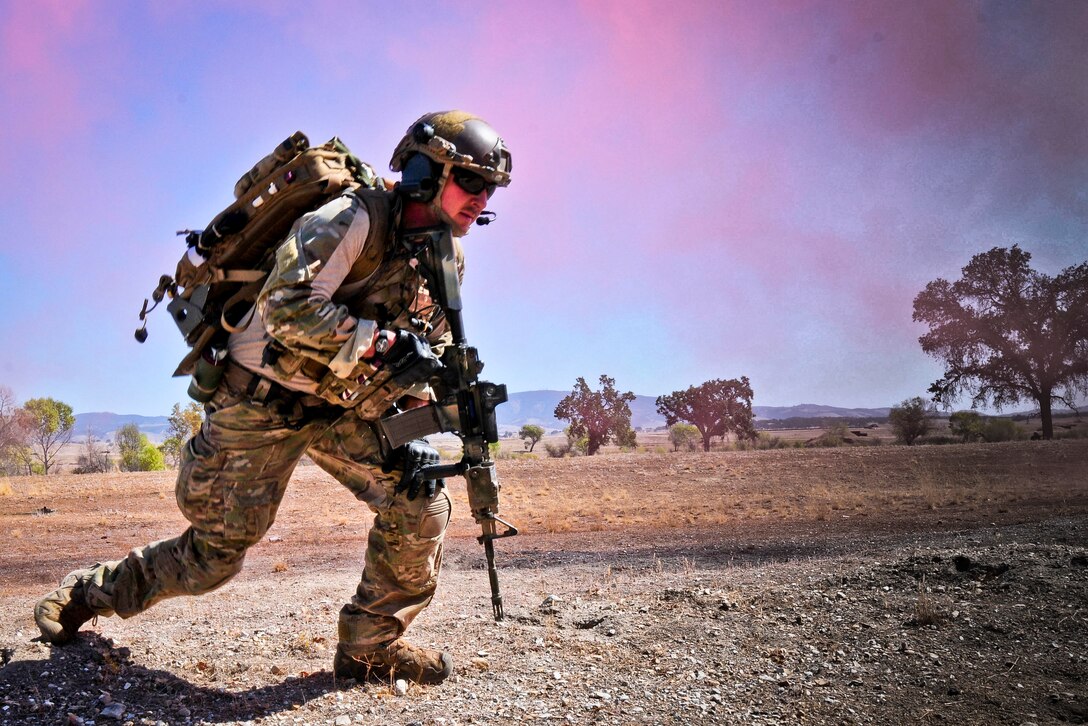 A Pararescueman from the 129th Rescue Wing, Moffett Federal Airfield Calif., conducts tactical field training for the 2014 Soaring Angel personnel recovery exercise at Fort Hunter Liggett, Oct. 2, 2014. The multi-day training scenarios satisfy readiness requirements in simulated deployment environments. (U.S. California Air National Guard photo by Senior Airman Rachael Kane/Released)