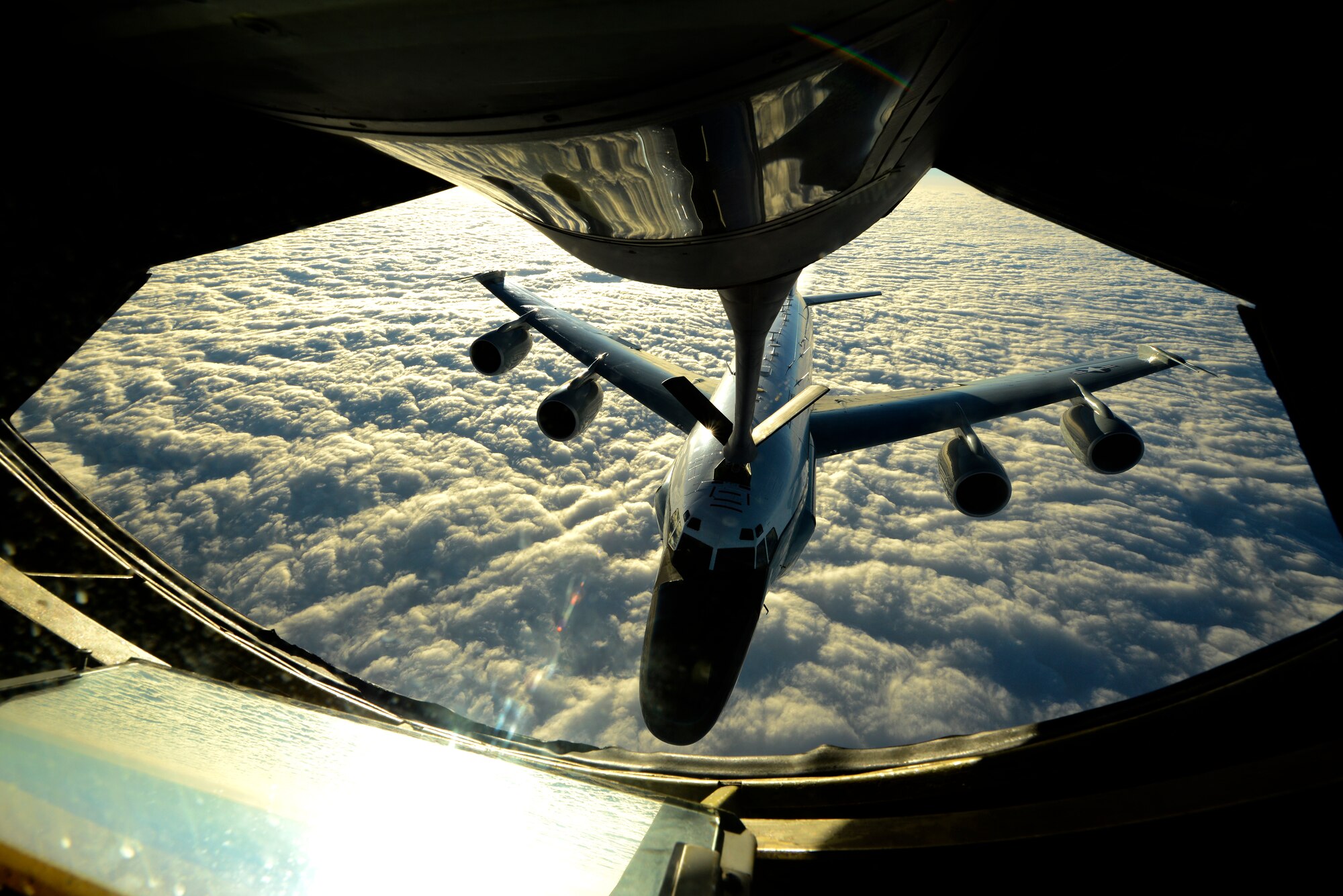 A U.S. Air Force KC-135 Stratotanker from the 909th Air Refueling Squadron refuels a U.S. Air Force RC-135W Rivet Joint reconnaissance aircraft from the 82nd Intelligence Squadron near Okinawa, Japan, Dec. 24, 2014. The 909th ARS is an essential component to the mid-air refueling of a multitude of aircraft ranging from fighter jets to cargo planes from different services and nations in the region. The 909th ARS and 82nd IS are stationed at Kadena Air Base, Japan. (U.S. Air Force photo by Senior Airman Maeson L. Elleman)