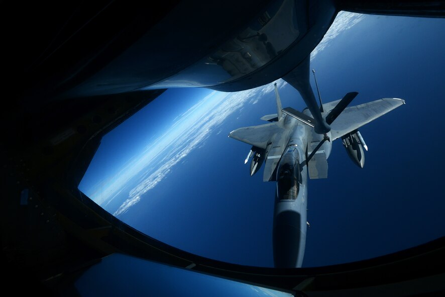 A U.S. Air Force KC-135 Stratotanker from the 909th Air Refueling Squadron refuels an F-15C Eagle near Okinawa, Japan, Dec. 23, 2014. The 909th ARS is an essential component to the mid-air refueling of a multitude of aircraft ranging from fighter jets to cargo planes from different services and nations in the region. The 909th ARS is stationed at Kadena Air Base, Japan. (U.S. Air Force photo by Senior Airman Maeson L. Elleman)
