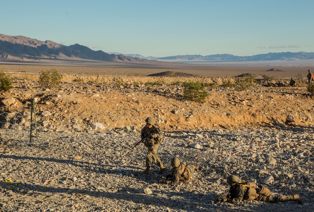 A U.S. Marine with Battalion Landing Team 3rd Battalion, 1st Marine Regiment, 15th Marine Expeditionary Unit, runs through a breach during a combined arms exercise aboard Marine Corps Air Ground Combat Center, Twentynine Palms, Calif., Dec. 13, 2014. BLT 3/1 conducted this training concurrent with the 15th MEU’s realistic urban training.  RUT prepares the 15th MEU’s Marines for their upcoming deployment, enhancing their combat skills in environments similar to those they may find in future missions. (U.S. Marine Corps Photo by Sgt. Emmanuel Ramos/Released)