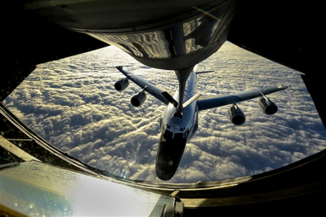 A U.S. Air Force KC-135 Stratotanker crew refuels a U.S. Air Force RC-135W Rivet Joint reconnaissance aircraft near Okinawa, Japan, Dec. 24, 2014. The KC-135 is assigned to the 909th Air Refueling Squadron. The RC-135W is assigned to the 82nd Intelligence Squadron.