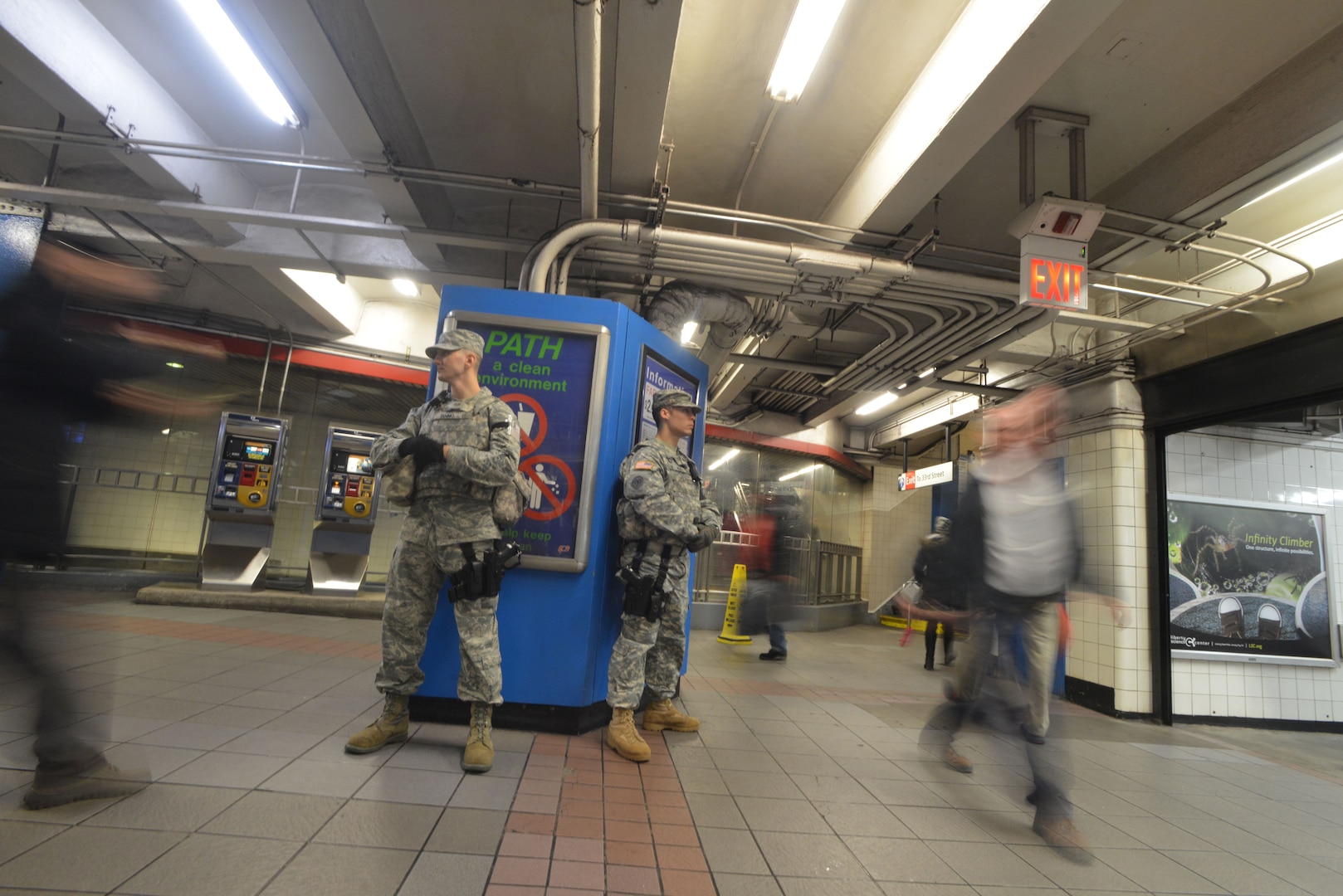 A New York National Guard Soldier and Airman assigned to Joint Task Force Empire Shield keep an eye on the crowd coming and going in New York City's Pennsylvania Station Amtrak terminal on  Tuesday, Dec. 23, 2014. The two are part of the New York National Guard's  500-member State Active Duty force that assists  the Metropolitan Transit Authority Police Department, the Bridge and Port Authority Police Department and the Amtrak Police at New York City's airports and key transit terminals. The uniformed National Guard members do not have arrest authority but provide additional eyes and assist police when requested.