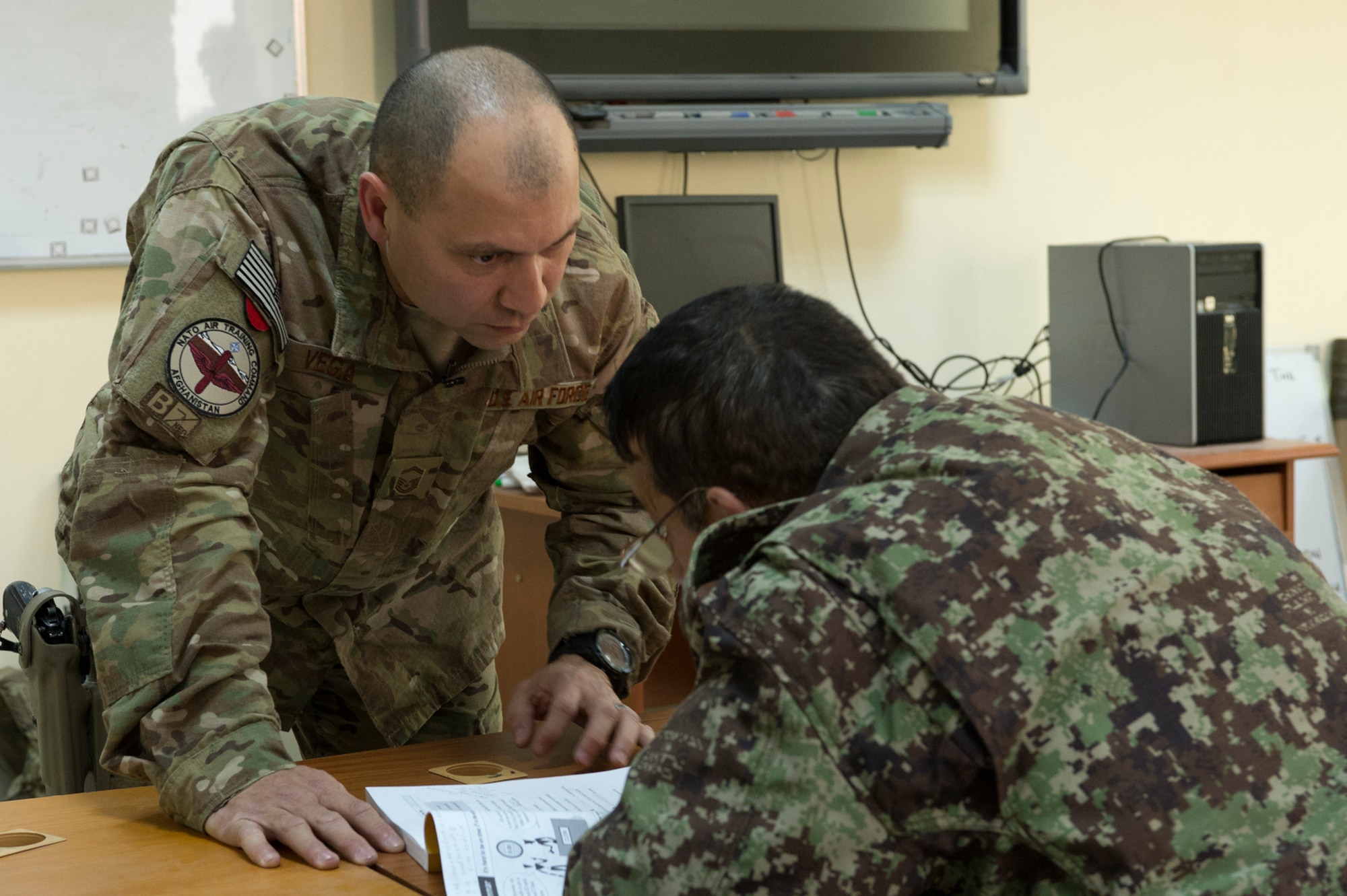 Senior Master Sgt. Carmelo Vega Martinez teaches an English class for Afghan airmen in Kabul, Afghanistan. Vega Martinez advises the Afghan air force on establishing and sustaining a recruiting service in addition to volunteering to teach English.  (U.S. Air Force photo/Tech. Sgt. Jason Robertson)