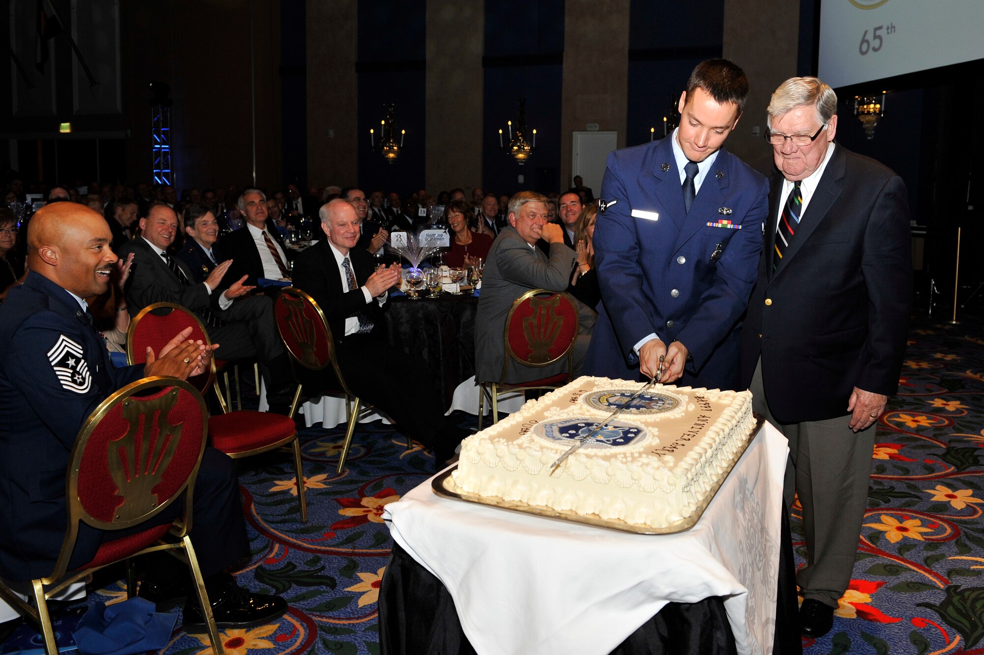 Major General Tim Padden (Ret.) and Airman Samuel Macklin, cut the ceremonial cake during a banquet hosted by the Space Foundation in honor of Air Force Space Command’s 30th anniversary celebration Sept. 14, 2012, Colorado Springs, Colo.  General Padden was the third Commander of Air Force Space Command and Airman Macklin is from the 721st Security Forces Squadron, Cheyenne Mountain Air Force Station. (U.S. Air Force photo/Staff Sgt. Christopher Boitz/Released)