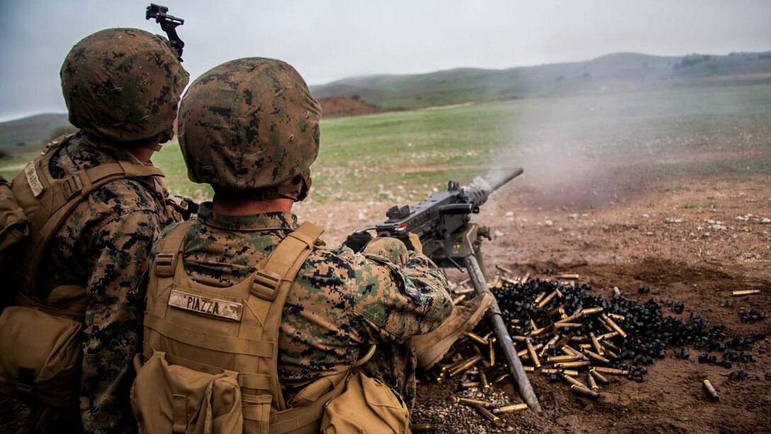 U.S. Marine Pfc. Jacob Piazza, right, fires a .50-caliber machine gun at targets during realistic urban training aboard Camp Roberts, Calif., Dec. 14, 2014. Piazza is a rifleman with Weapons Company, Battalion Landing Team 3rd Battalion, 1st Marine Regiment, 15th Marine Expeditionary Unit. The training prepares the 15th MEU’s Marines for their upcoming deployment, enhancing their combat skills in environments similar to those they may find in future missions. 